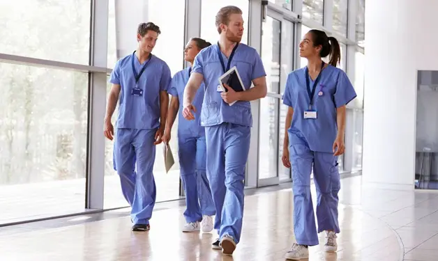 A group of doctors walking in the hallway.